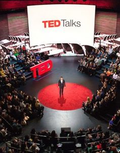 Picture of a ted talk conference with audience